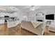 Bright living room featuring hardwood floors, fireplace and view into modern white kitchen at 111 Ferncroft Ct, Cary, NC 27519