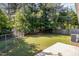 Backyard featuring a grassy lawn, a wooden fence, and trees at 1110 Allgood St, Durham, NC 27704