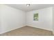 A bedroom with neutral carpet, natural light, flush mount light, and window at 1110 Allgood St, Durham, NC 27704