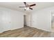 Bedroom featuring ceiling fan, wood flooring, and entry to a bathroom at 1110 Allgood St, Durham, NC 27704