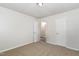 Bedroom featuring neutral carpet, an open doorway, and doors to other rooms at 1110 Allgood St, Durham, NC 27704
