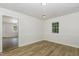 Dining area with wood-look flooring, a window, and white wainscoting at 1110 Allgood St, Durham, NC 27704