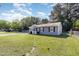 Side view of a cozy, single-story home with a spacious green lawn and mature trees at 1110 Allgood St, Durham, NC 27704
