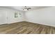 Bright living room featuring wood-look flooring, white walls, and a ceiling fan at 1110 Allgood St, Durham, NC 27704