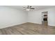 Open living space with wood-look flooring, white walls, and access to the kitchen at 1110 Allgood St, Durham, NC 27704