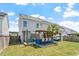 Home's backyard featuring outdoor bar, seating areas, and solar panels at 1161 Tulip Poplar Rd, Fuquay Varina, NC 27526
