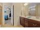 Modern bathroom featuring a large double vanity and doorway to an adjacent bedroom at 1161 Tulip Poplar Rd, Fuquay Varina, NC 27526