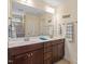Bathroom featuring double vanity, framed mirror, and a tile shower at 1161 Tulip Poplar Rd, Fuquay Varina, NC 27526