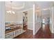 Dining room featuring tray ceilings, a chandelier, and a view into the kitchen with stainless steel appliances at 1161 Tulip Poplar Rd, Fuquay Varina, NC 27526