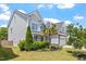 Charming two-story home with a two car garage, stone accents, manicured lawn, and mature landscaping at 1161 Tulip Poplar Rd, Fuquay Varina, NC 27526