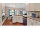 Charming kitchen features granite counters, stainless appliances, and a breakfast bar flowing to the dining area at 1161 Tulip Poplar Rd, Fuquay Varina, NC 27526