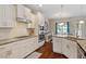 Elegant kitchen with stainless appliances, granite countertops, seamlessly blending into the dining and living areas at 1161 Tulip Poplar Rd, Fuquay Varina, NC 27526
