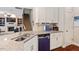 Well-appointed kitchen features a breakfast bar, stainless steel appliances and an open view to the living areas at 1161 Tulip Poplar Rd, Fuquay Varina, NC 27526