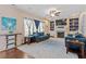 Spacious living room featuring a ceiling fan, hardwood floors, fireplace, and custom shelving at 1161 Tulip Poplar Rd, Fuquay Varina, NC 27526