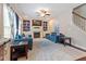 Spacious living room featuring a ceiling fan, hardwood floors, fireplace, and custom shelving at 1161 Tulip Poplar Rd, Fuquay Varina, NC 27526