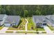 Aerial view highlighting a sidewalk, landscaping, and streetscape in a residential neighborhood with well-maintained homes and yards at 1177 Sun Springs Rd, Wake Forest, NC 27587