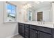 Bathroom featuring double vanity, generous mirror and bright window at 1177 Sun Springs Rd, Wake Forest, NC 27587