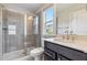 Bright bathroom features a glass enclosed shower, modern vanity and a window that lets in natural light at 1177 Sun Springs Rd, Wake Forest, NC 27587
