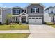 Charming two-story home with gray siding, white trim, and an attached two-car garage at 1177 Sun Springs Rd, Wake Forest, NC 27587