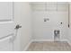 A bright laundry room with tiled flooring and hookups at 1177 Sun Springs Rd, Wake Forest, NC 27587
