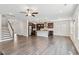Open-concept living space featuring wood floors, a modern kitchen, and a staircase at 1177 Sun Springs Rd, Wake Forest, NC 27587