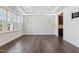 Spacious living room with wood floors, a tray ceiling, and lots of natural light from large windows at 1177 Sun Springs Rd, Wake Forest, NC 27587