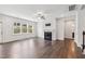 Inviting living room with a fireplace, large windows, and wood flooring throughout at 1177 Sun Springs Rd, Wake Forest, NC 27587