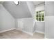Simple bedroom with an angled ceiling and a large window with lots of light at 119 Palace Grn, Cary, NC 27518