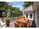 Deck with a brown wood table, chairs, and view of trees in the back yard at 119 Palace Grn, Cary, NC 27518