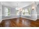 Dining room with hardwood floors, natural light, and elegant chandelier at 119 Palace Grn, Cary, NC 27518