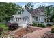 Charming home featuring a brick walkway, gray siding, and a cozy front porch, beautifully landscaped at 119 Palace Grn, Cary, NC 27518