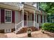 Home with charming brick stairs, red shutters, and cedar shake roof at 119 Palace Grn, Cary, NC 27518