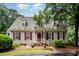 Charming home featuring a cedar shake roof, brick entryway, and well-maintained landscaping at 119 Palace Grn, Cary, NC 27518