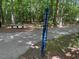 Swift Creek Greenway trail marker alongside a paved path, nestled within lush trees at 119 Palace Grn, Cary, NC 27518