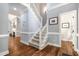 Hallway with wood flooring, trim detail, staircase, and natural light at 119 Palace Grn, Cary, NC 27518