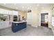 Bright kitchen with white cabinets, yellow walls, and a blue kitchen island with a smooth countertop at 119 Palace Grn, Cary, NC 27518