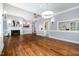 Open-concept living room featuring a fireplace, hardwood floors, and views of other rooms at 119 Palace Grn, Cary, NC 27518