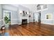 Open-concept living room with hardwood floors, natural light and a fireplace at 119 Palace Grn, Cary, NC 27518