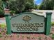 Community entrance sign for Williamsburg Commons amidst lush greenery at 119 Palace Grn, Cary, NC 27518