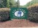 This image displays the Lochmere Golf Club sign surrounded by green shrubbery at 119 Palace Grn, Cary, NC 27518