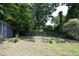 Spacious backyard with garden beds, storage shed, mature trees, and a serene setting at 120 Pine St, Carrboro, NC 27510