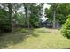 Expansive backyard featuring mature trees, a fenced perimeter, and lush greenery at 120 Pine St, Carrboro, NC 27510