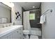 Modern bathroom with tiled shower, gray vanity, and neutral decor at 120 Pine St, Carrboro, NC 27510