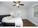 Inviting bedroom features a ceiling fan, hardwood floors, and neutral tones at 120 Pine St, Carrboro, NC 27510