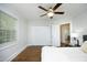 Cozy bedroom with a ceiling fan, closet, and wood flooring at 120 Pine St, Carrboro, NC 27510