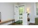 Bright entryway featuring hardwood floors, a charming front door, and a view of the front porch at 120 Pine St, Carrboro, NC 27510