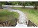 Stone and concrete walkway in the front yard with a black railing and stone accents at 120 Pine St, Carrboro, NC 27510