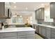 Open kitchen with gray cabinets, white countertops and a view to the living room at 120 Pine St, Carrboro, NC 27510