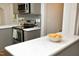 Kitchen peninsula features white quartz countertops and stainless steel appliances at 120 Pine St, Carrboro, NC 27510