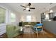 A spacious living room featuring neutral paint, hardwood flooring, modern furniture, and ample lighting at 120 Pine St, Carrboro, NC 27510